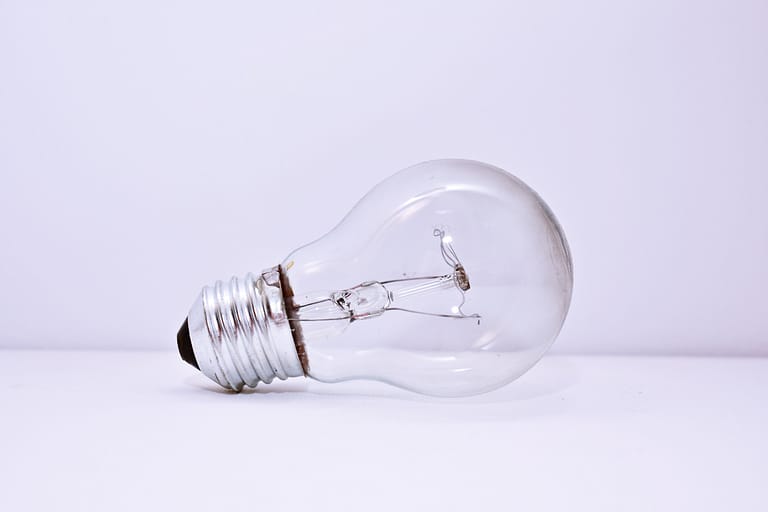 A light bulb lies on a white table